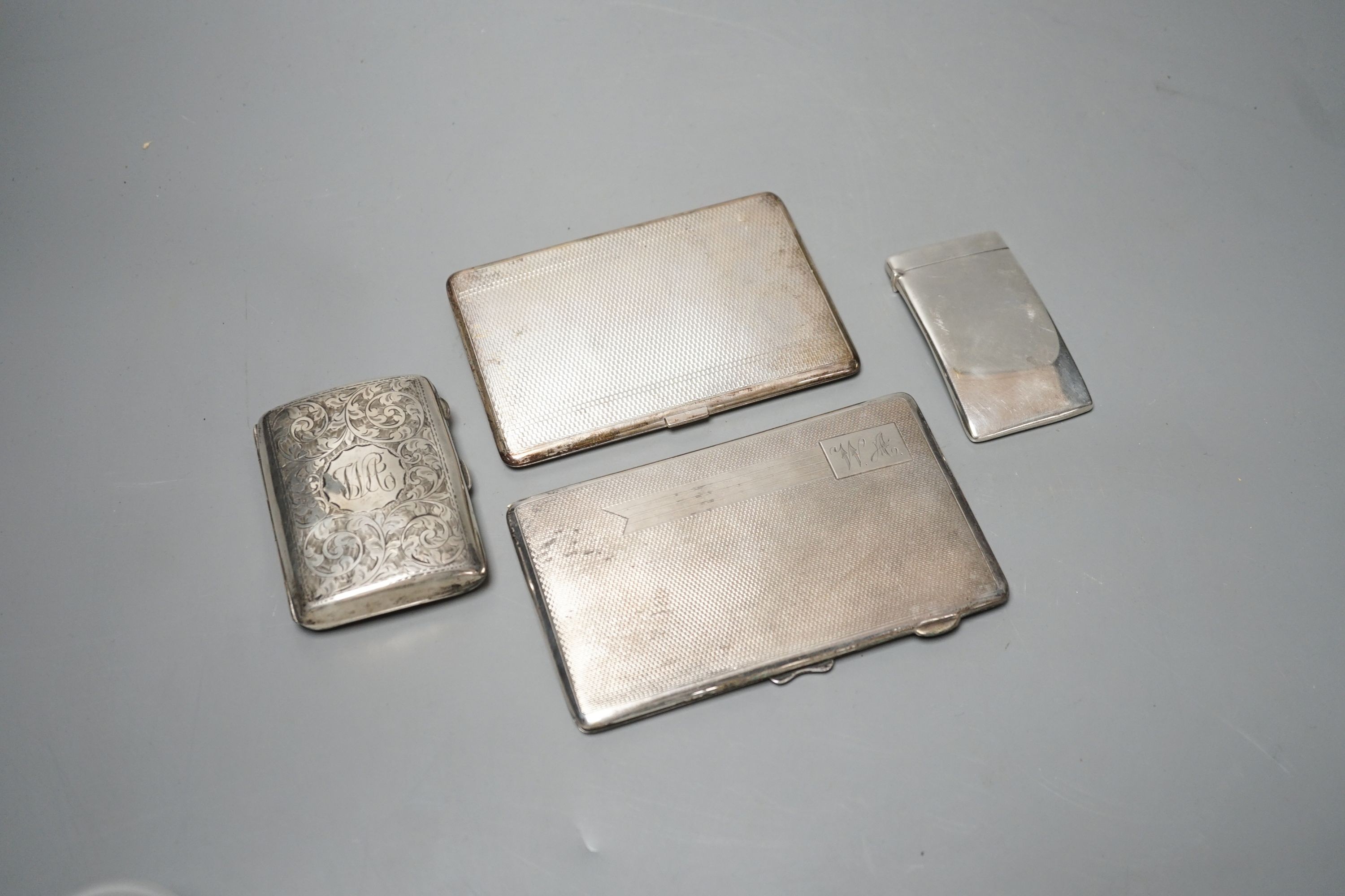 Three assorted silver cigarette cases and a silver card case, largest 14cm, gross 14oz.